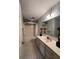 Bathroom offers vanity sink, blue wallpaper, and shower and tub combination at 4586 Aldersgate Dr, Carmel, IN 46033