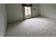Bright bedroom features neutral carpet and window with floral curtains at 4586 Aldersgate Dr, Carmel, IN 46033