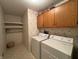 Laundry room features a washing machine, dryer, and shelves at 4586 Aldersgate Dr, Carmel, IN 46033