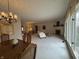 Large living room featuring a dining space, fireplace, and big windows at 4586 Aldersgate Dr, Carmel, IN 46033