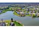 Picturesque aerial view of a lakeside home nestled in a tranquil suburban community with well-maintained lawns and scenic waterfront at 4827 Spring Flower Ct, Indianapolis, IN 46237