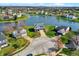 A picturesque aerial view of a lakeside home with lush green landscaping at 4827 Spring Flower Ct, Indianapolis, IN 46237