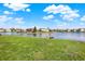 Lush green backyard overlooking a peaceful lake with a small wooden dock at 4827 Spring Flower Ct, Indianapolis, IN 46237