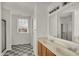 Bright bathroom with double sinks, a large mirror and a walk-in shower at 4827 Spring Flower Ct, Indianapolis, IN 46237