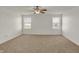Expansive bedroom features a ceiling fan, large windows and neutral-toned carpet at 4827 Spring Flower Ct, Indianapolis, IN 46237