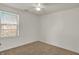 This bedroom features neutral walls, a ceiling fan, and natural light at 4827 Spring Flower Ct, Indianapolis, IN 46237