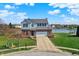 Charming two-story home featuring a brick facade, attached garage, and a well-manicured lawn near a serene lake at 4827 Spring Flower Ct, Indianapolis, IN 46237
