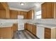 Functional kitchen with ample cabinet space, white appliances, and durable flooring at 4827 Spring Flower Ct, Indianapolis, IN 46237