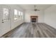 Spacious living room featuring a fireplace, ceiling fan, and beautiful plank flooring at 4827 Spring Flower Ct, Indianapolis, IN 46237
