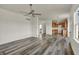 Living room boasts vinyl floors, ceiling fan, and seamlessly connects to the kitchen at 4827 Spring Flower Ct, Indianapolis, IN 46237