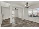 Bright living room features elegant chandelier lighting, sleek vinyl floors, and plentiful natural light at 4827 Spring Flower Ct, Indianapolis, IN 46237