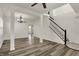 This living room features vinyl floors, modern lighting, and staircase at 4827 Spring Flower Ct, Indianapolis, IN 46237
