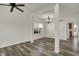 Bright living room with vinyl floors, contemporary ceiling fan, chandelier lighting, and natural light at 4827 Spring Flower Ct, Indianapolis, IN 46237