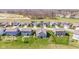 An aerial view displays a street in a residential area with well-kept lawns and varied house designs at 5083 Castamere Dr, Noblesville, IN 46062