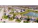 Attractive aerial view of suburban homes including pond with fountain and manicured lawns at 5083 Castamere Dr, Noblesville, IN 46062