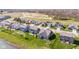 An aerial view depicts a residential community with attractive homes, green lawns, and a construction site at 5083 Castamere Dr, Noblesville, IN 46062