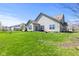 Back yard featuring a well-maintained lawn, mature trees and beautiful landscaping at 5083 Castamere Dr, Noblesville, IN 46062