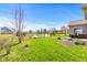 Exterior view of the back of the home showing the back yard with a pond at 5083 Castamere Dr, Noblesville, IN 46062
