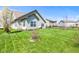 Back yard featuring manicured lawn, beautiful landscaping, and mature trees at 5083 Castamere Dr, Noblesville, IN 46062