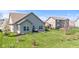 A fenced yard features a patio with seating; the home boasts a light gray exterior and well-maintained lawn at 5083 Castamere Dr, Noblesville, IN 46062