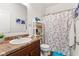 Bathroom with floral shower curtain, marble vanity, and decorative wall art at 5083 Castamere Dr, Noblesville, IN 46062