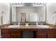 Bathroom featuring double sinks with brown countertops and a large mirror at 5083 Castamere Dr, Noblesville, IN 46062