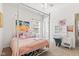 Comfortable bedroom with a four-poster bed, pink bedding, and a white vanity table with decor at 5083 Castamere Dr, Noblesville, IN 46062
