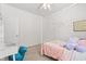 Bright bedroom featuring a four-poster bed, whimsical wall decor, and a white door at 5083 Castamere Dr, Noblesville, IN 46062