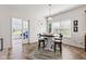 Bright dining area featuring a pendant light and large windows offering natural light at 5083 Castamere Dr, Noblesville, IN 46062