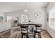 Dining area featuring a dining table, a large decorative wall clock, and bright natural light at 5083 Castamere Dr, Noblesville, IN 46062