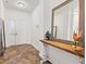 Bright entryway featuring neutral walls, tile floors, a rustic wooden console table and white front door at 5083 Castamere Dr, Noblesville, IN 46062