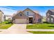 Exterior view of a two-story brick home with a driveway and a two-car garage at 5083 Castamere Dr, Noblesville, IN 46062