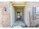 Inviting entryway with brick facade, covered porch, and a modern black front door with glass detail at 5083 Castamere Dr, Noblesville, IN 46062