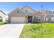 Charming brick home featuring an attached two-car garage and a well-manicured lawn on a sunny day at 5083 Castamere Dr, Noblesville, IN 46062
