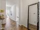 Hallway with tile flooring, neutral paint, large framed mirror and views of the living spaces at 5083 Castamere Dr, Noblesville, IN 46062