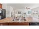 Open-concept kitchen overlooking a living area, stainless steel sink, and modern appliances in neutral color tones at 5083 Castamere Dr, Noblesville, IN 46062