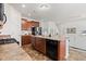 Eat-in kitchen featuring dark wood cabinets, a black dishwasher, and laminate countertops at 5083 Castamere Dr, Noblesville, IN 46062