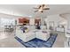Open-concept living space with sectional, kitchen, and dining area for easy entertaining at 5083 Castamere Dr, Noblesville, IN 46062