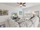 Bright living room features a cozy sectional, TV, and serene neighborhood views at 5083 Castamere Dr, Noblesville, IN 46062