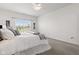 Bright main bedroom with a king-sized bed with white bedding, ceiling fan, and natural light at 5083 Castamere Dr, Noblesville, IN 46062