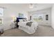 Calming main bedroom featuring a king-sized bed with white bedding, ceiling fan, and natural light at 5083 Castamere Dr, Noblesville, IN 46062