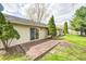 Backyard view features a deck attached to the house, complete with well-maintained green grass and landscaping at 509 Nelson Dr, Brownsburg, IN 46112