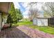 A wooden deck enhances the backyard with a storage shed and spacious green lawn on a partly cloudy day at 509 Nelson Dr, Brownsburg, IN 46112