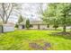 Backyard with green grass, trees, a shed, and a sliding glass door into the house for easy access at 509 Nelson Dr, Brownsburg, IN 46112