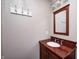 Bathroom vanity with dark wood cabinets, an undermount sink, and decorative wall hardware at 509 Nelson Dr, Brownsburg, IN 46112