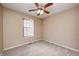 A neutral-toned bedroom features carpeted floors, a ceiling fan, and a window with blinds at 509 Nelson Dr, Brownsburg, IN 46112