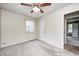 Spacious bedroom with light-colored walls, carpeted floors, and a modern ceiling fan at 509 Nelson Dr, Brownsburg, IN 46112