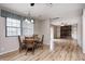 Open-concept dining area boasts hardwood floors and connects to the living room with a brick fireplace at 509 Nelson Dr, Brownsburg, IN 46112