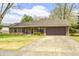 Charming single-story home featuring a well-manicured lawn and an attached two-car garage at 509 Nelson Dr, Brownsburg, IN 46112