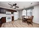 Eat-in kitchen includes wooden cabinets, white appliances, and a dining table with seating at 509 Nelson Dr, Brownsburg, IN 46112